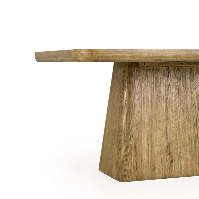 Close-up of wood dining table base with visible grain texture and panel edges