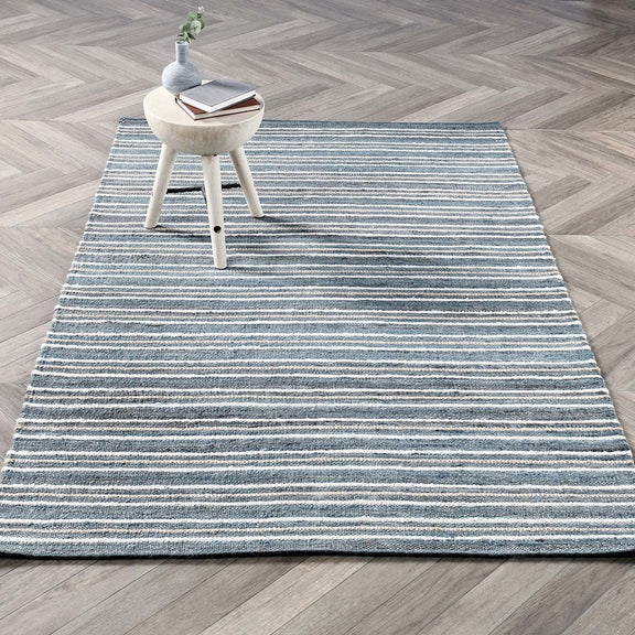 2.6 ft x 8 ft striped rug with blue bands over dark blue ground