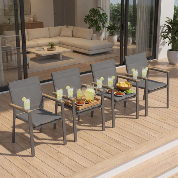 Dark gray patio dining chairs with woven seats and wood-toned armrest bars on wooden deck