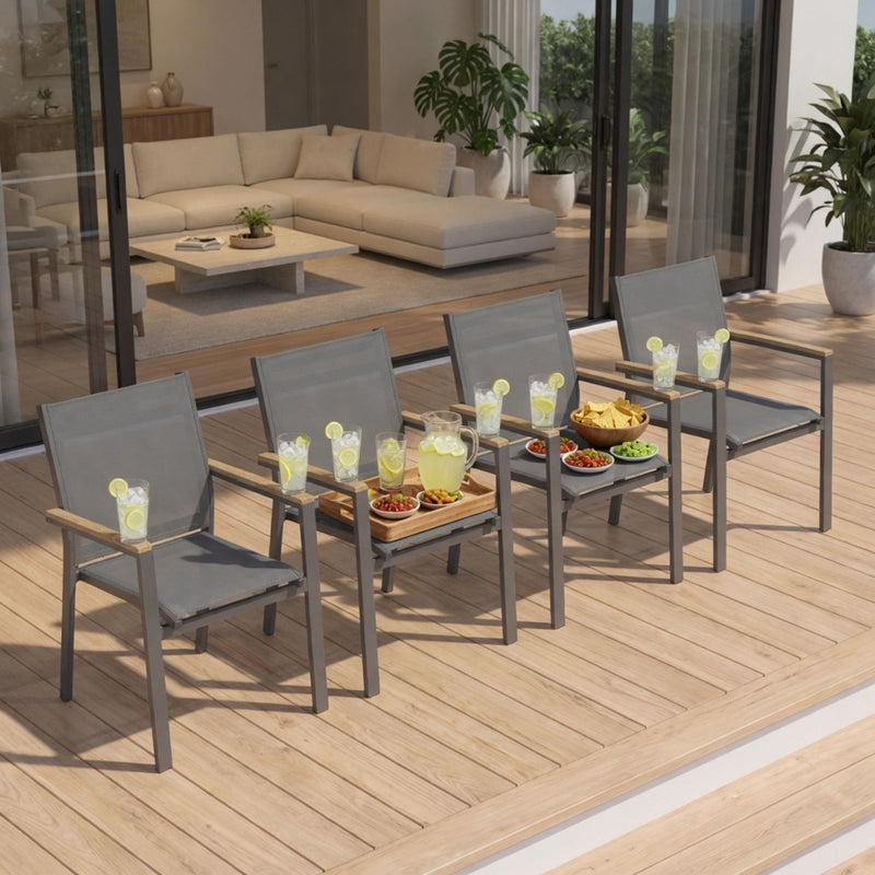 Dark gray patio dining chairs with woven seats and wood-toned armrest bars on wooden deck