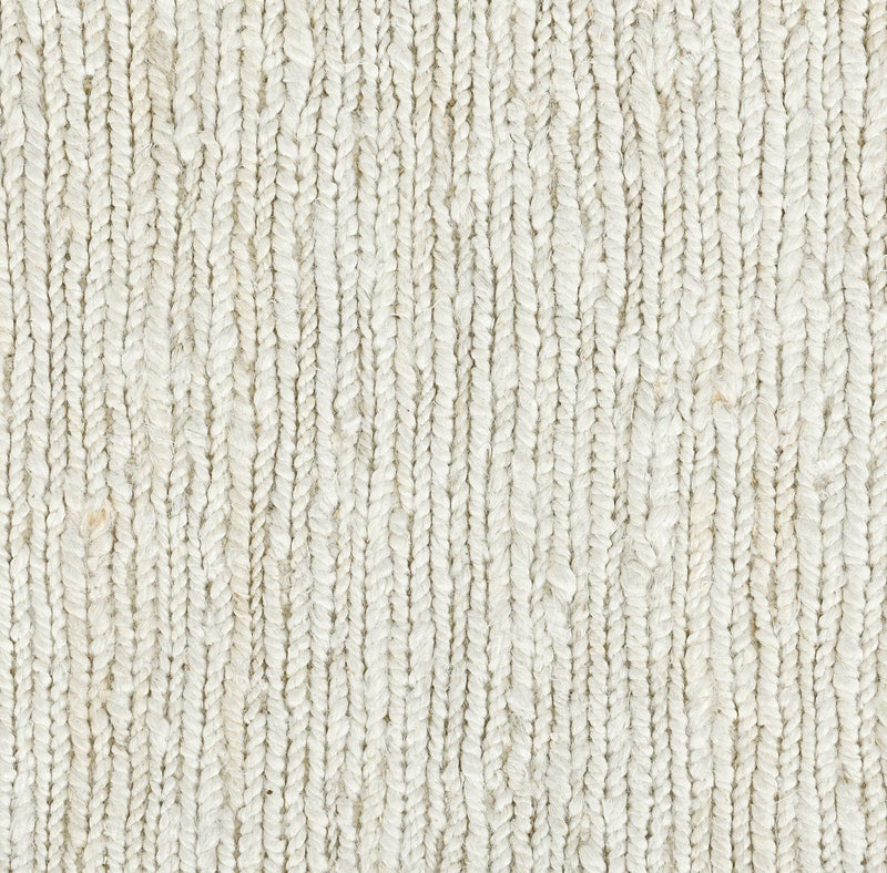 Ivory white jute rug surface close-up, dense flatwoven texture.