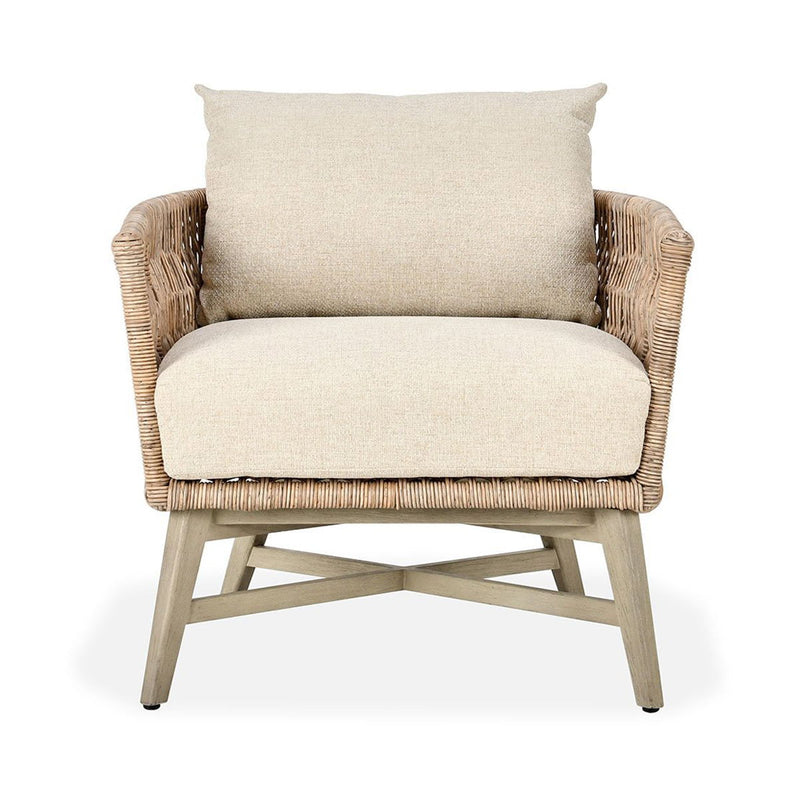 Outdoor accent chair with tall woven sides, sand upholstered seat, and back cushion