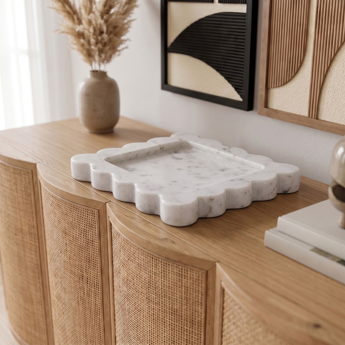White genuine marble tray with scalloped rim placed on a wooden tabletop