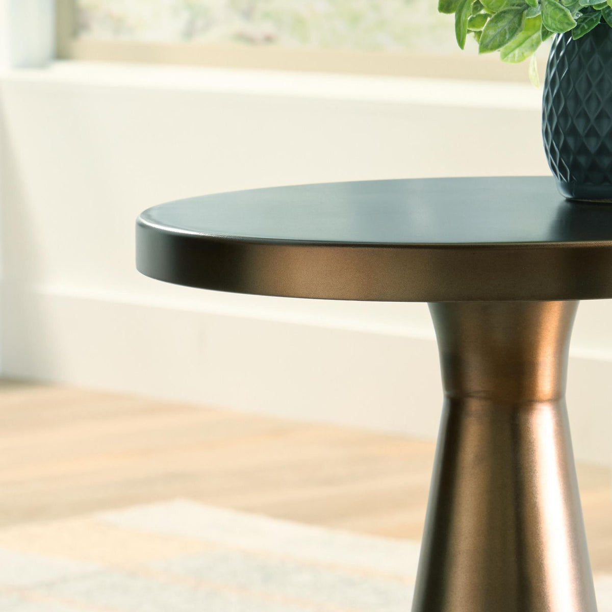 Light bronze accent table top edge and tapered pedestal base