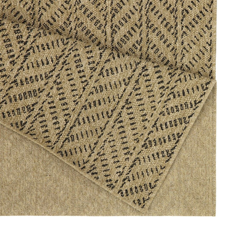 Light brown indoor/outdoor area rug close-up with dark dotted chevron pattern