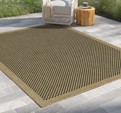 Light brown indoor-outdoor area rug with black-and-brown checkered pattern border