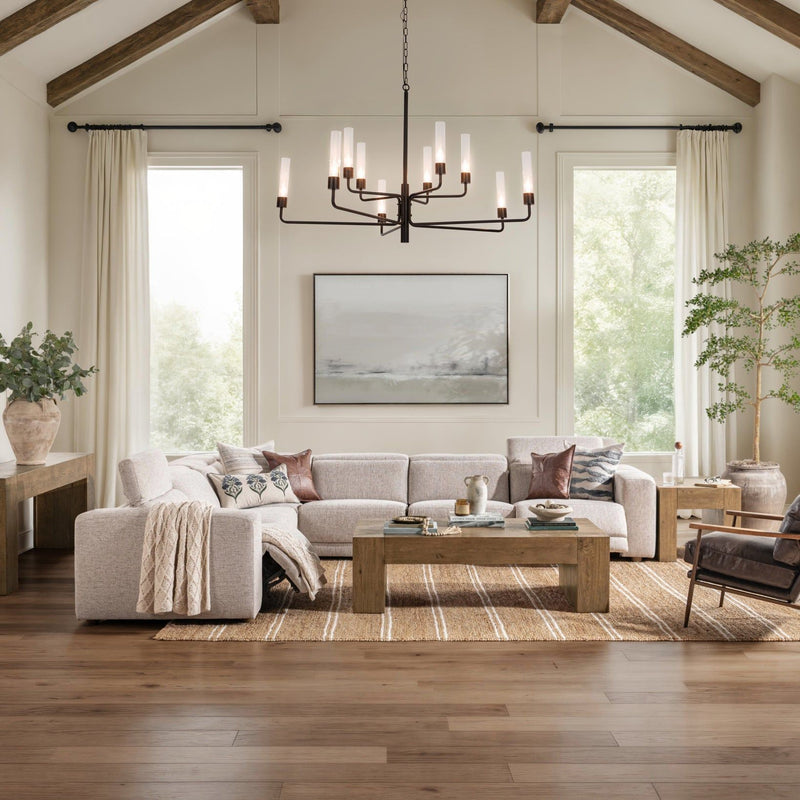 Gray sectional sofa in a living room with patterned rug and throw pillows
