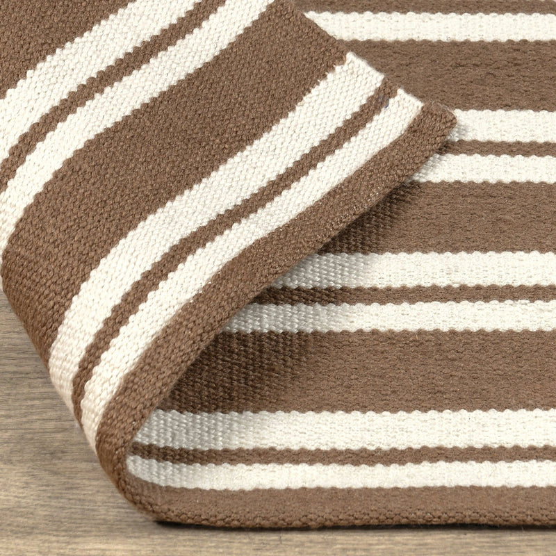 Coconut brown and white striped rug corner detail with flat woven texture