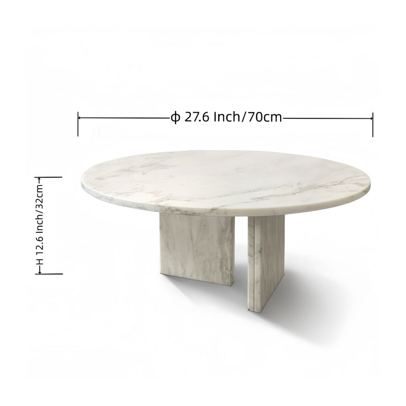 Round white marble coffee table with subtle gray veining and light stone pedestal legs