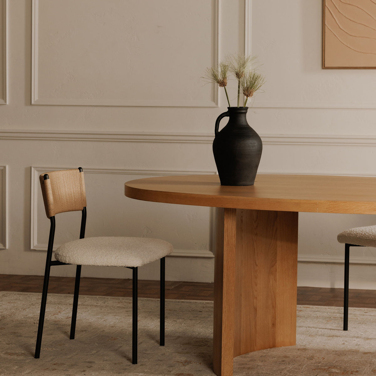 Foley dining chair with a white upholstered seat, woven tan back, and black metal frame