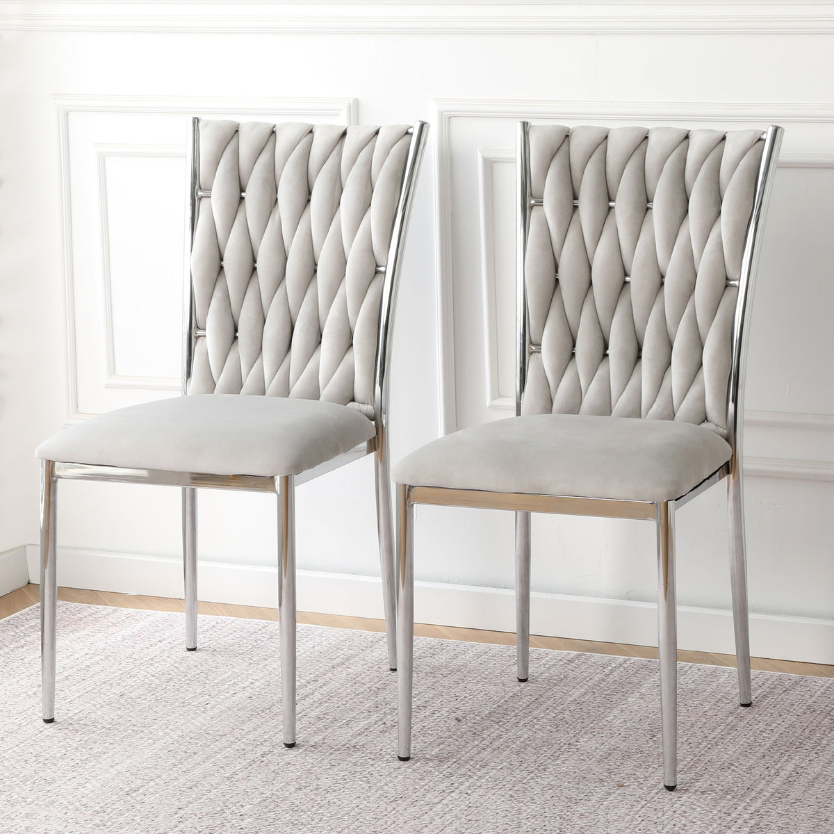Pair of ivory tufted dining chairs with diamond back and chrome legs