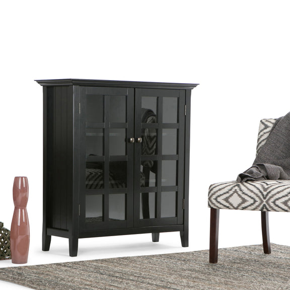 Medium storage cabinet with dark gray finish, glass-paneled doors, and metal knobs