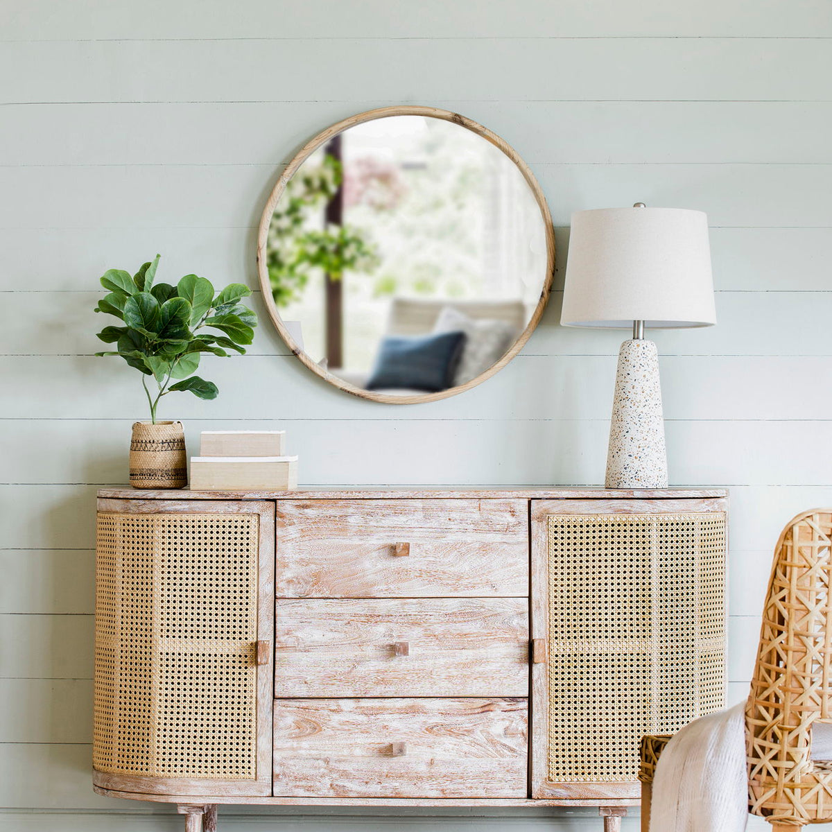 TV console with cane doors, three drawers, distressed pale wood finish, and tapered legs