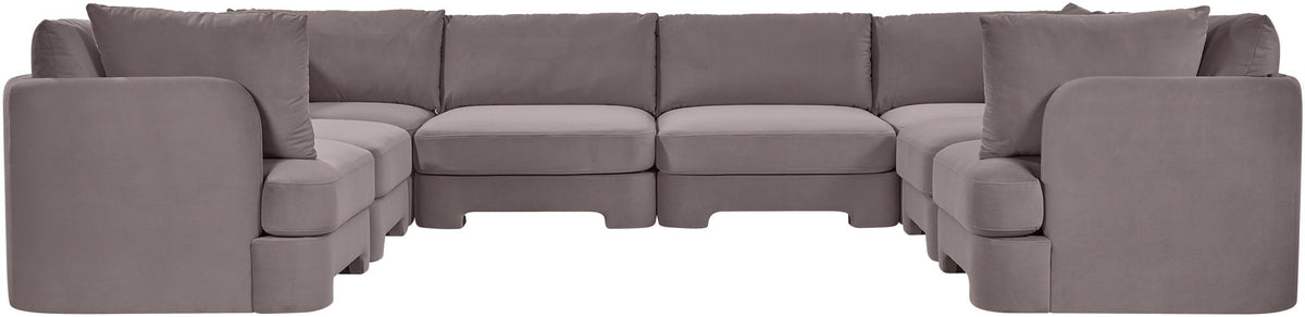 Gray velvet U-shaped sectional sofa with rounded arm sections and multiple seat modules