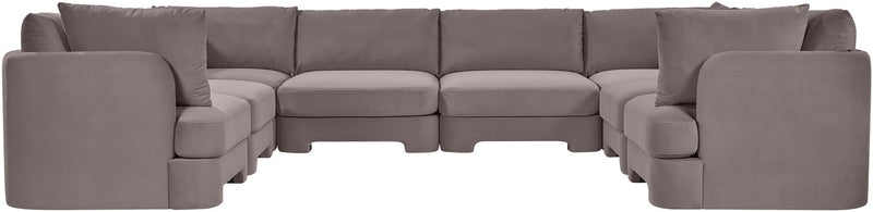 Gray velvet U-shaped sectional sofa with rounded arm sections and multiple seat modules