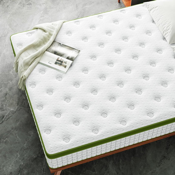 White mattress with green piping, quilted top with small rounded bumps.
