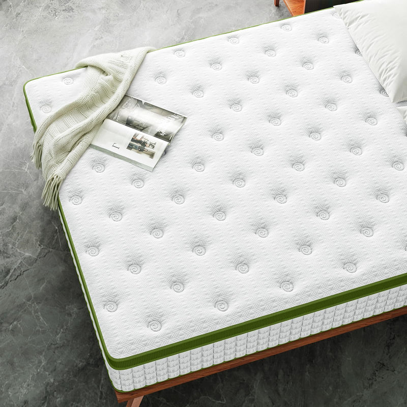 White mattress with green piping, quilted top with small rounded bumps.