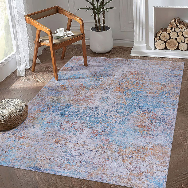 Light blue and cream distressed ornate area rug, rectangular with vintage-style motifs.
