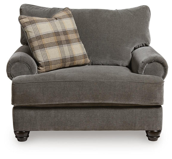 Shadow gray accent chair and a half with plaid throw pillow and curved rolled arms