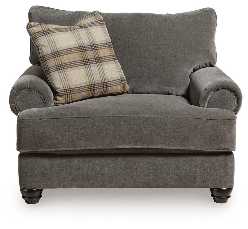 Shadow gray accent chair and a half with plaid throw pillow and curved rolled arms
