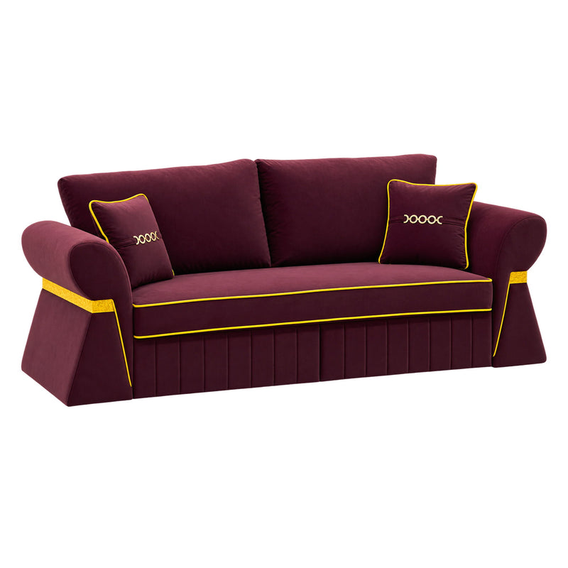 Dark red three-seat sofa with two cushions and gold-tone piping, angled view