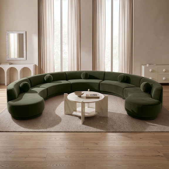 Green performance velvet sectional sofa with rounded ottoman-style sections and bolsters