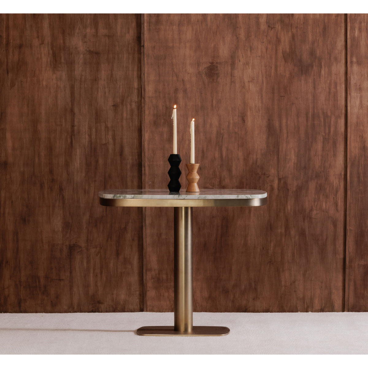 Round cafe table with marble-look top, antique brass stand, and candles on it
