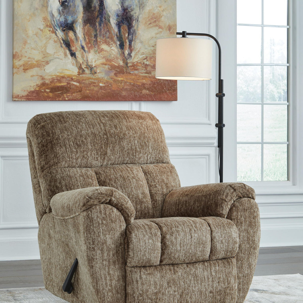 Light brown rocker recliner chair with padded arms and plush backrest