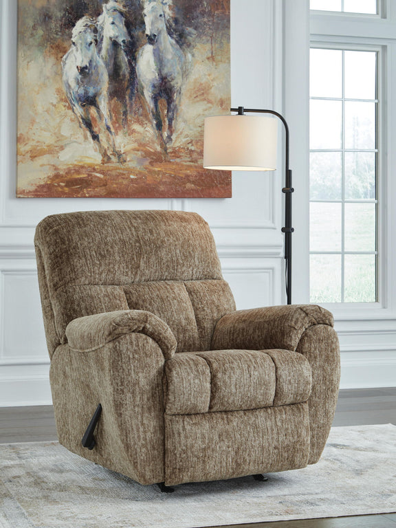 Light brown rocker recliner chair with padded arms and plush backrest