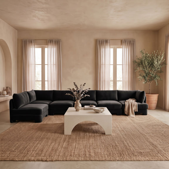 Black L-shaped armless sectional sofa with velvet-look upholstery and chaise corner