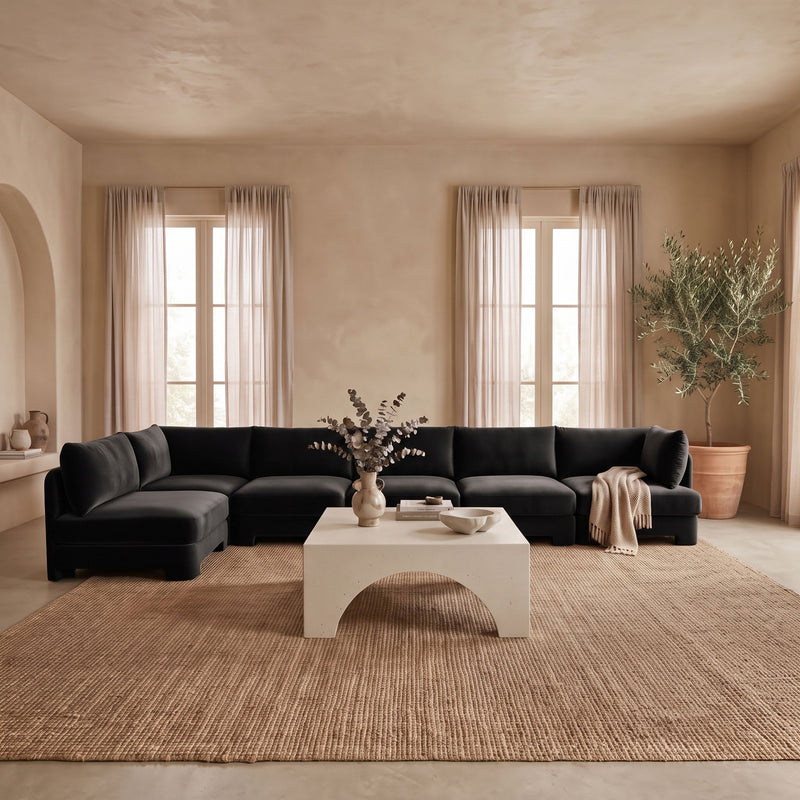 Black L-shaped armless sectional sofa with velvet-look upholstery and chaise corner