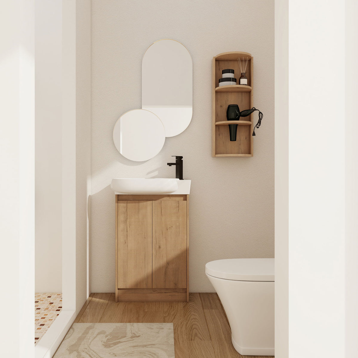 Light wood freestanding bathroom vanity with oval sink and two cabinet doors, plus wall storage