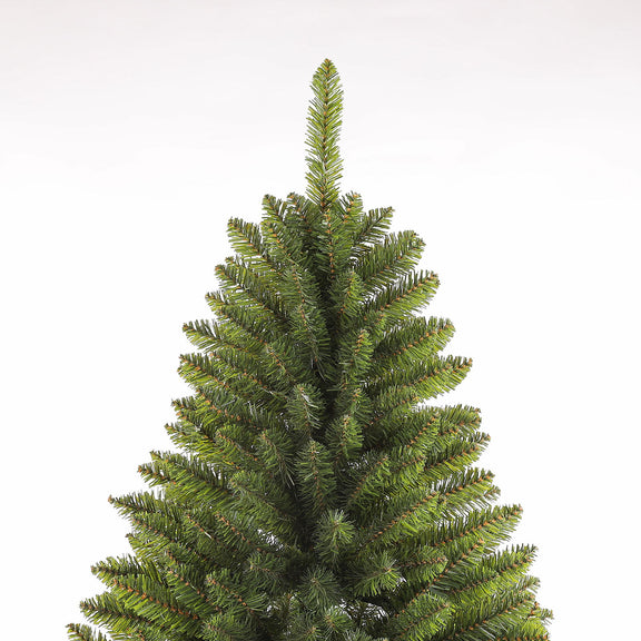 Dark green artificial Christmas tree close-up, full silhouette with layered tips