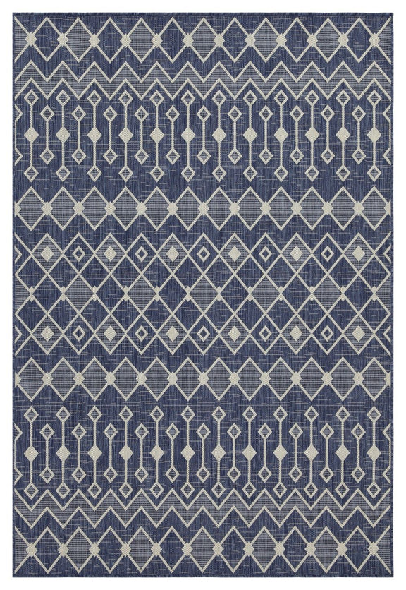 Indoor/outdoor polypropylene area rug, navy with light blue diamond and chevron motifs.