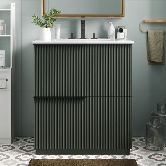 Dark green fluted bathroom vanity with white ceramic sink and center handle bar