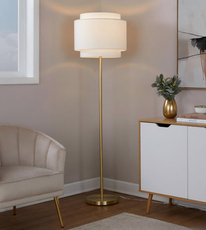 Gold-tone contemporary floor lamp with white fabric drum shade and round base