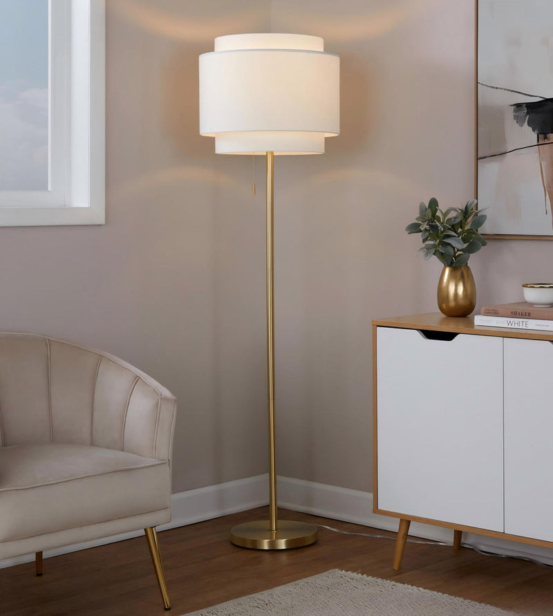 Gold-tone contemporary floor lamp with white fabric drum shade and round base