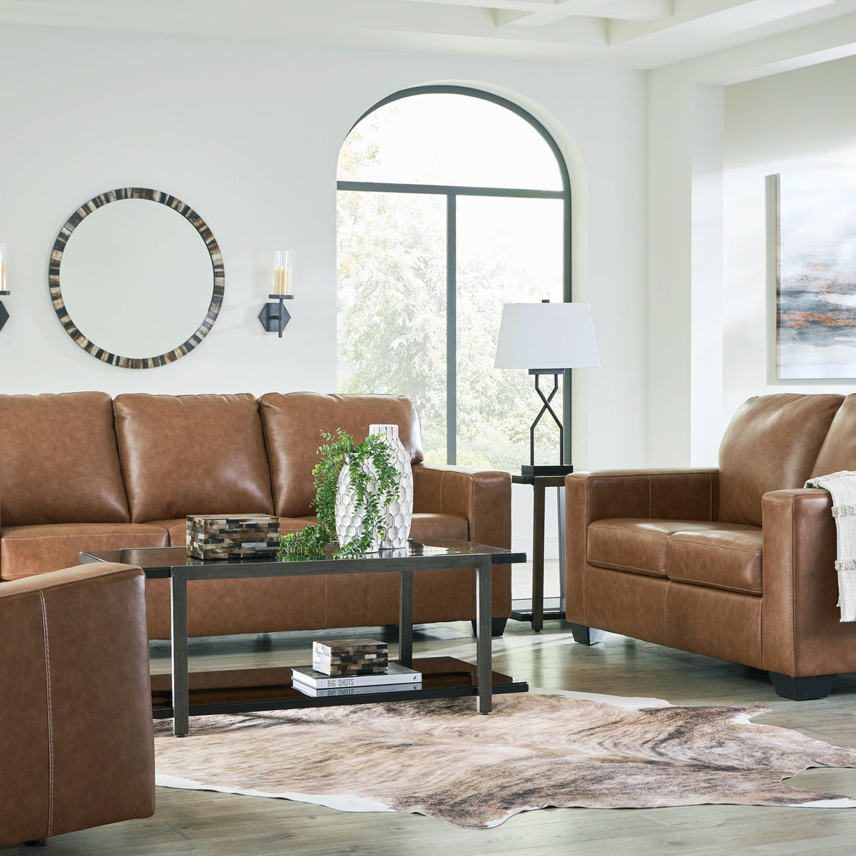 Brown upholstered seating set with tufted backs and padded arms