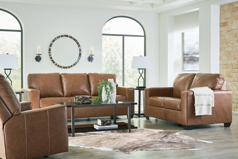 Brown upholstered seating set with tufted backs and padded arms
