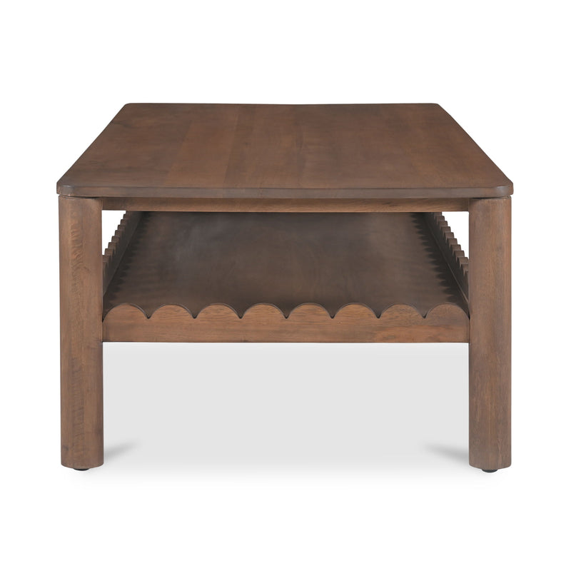 Vintage brown coffee table from front with scalloped apron and open lower shelf.