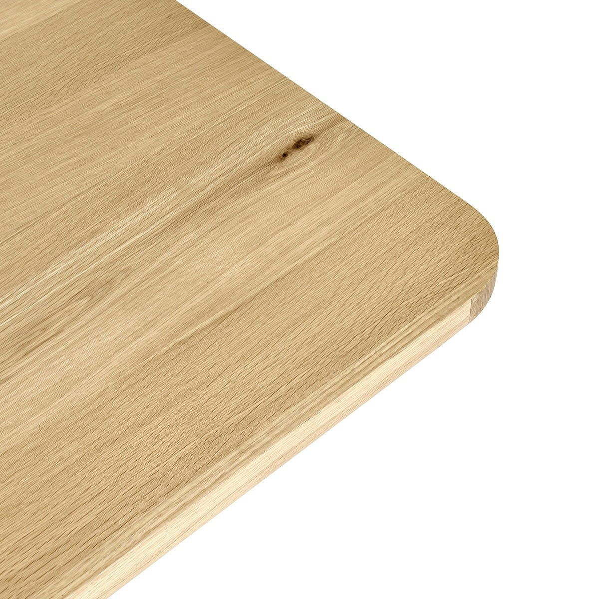 Light wood dining table with rounded corner edge detail and visible grain
