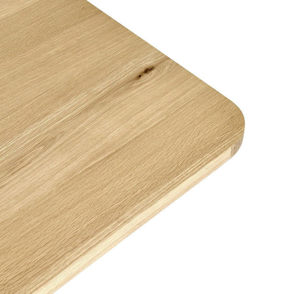 Light wood dining table with rounded corner edge detail and visible grain