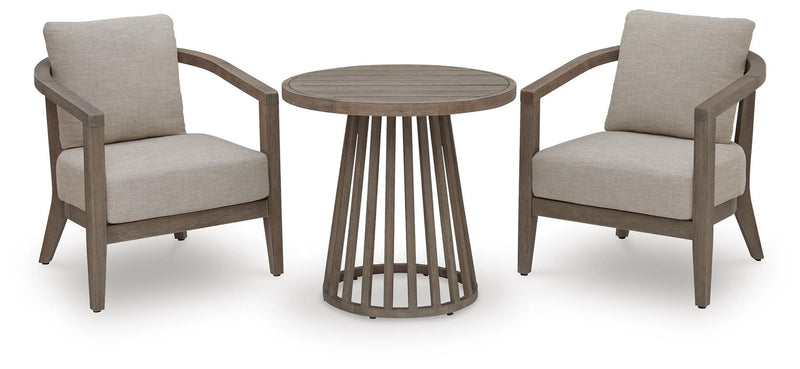 Outdoor patio set with two beige armchairs and round slatted side table with cushions