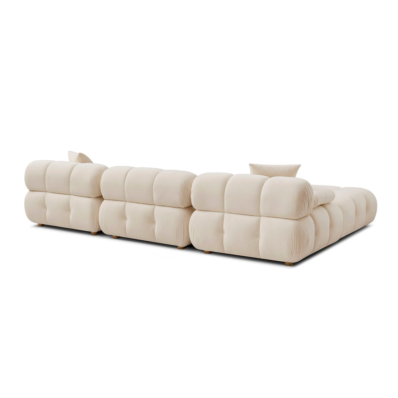 Cream modular sectional sofa with tufted cushions and multiple back pillows