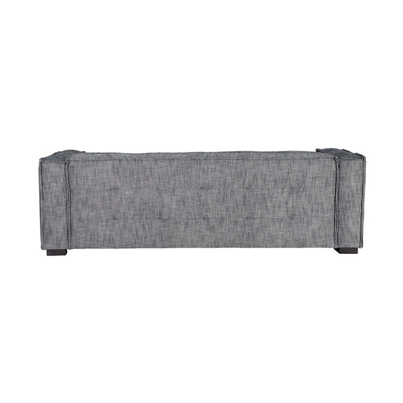 Gray fabric sofa back panel with tufted upholstery and dark wooden legs.