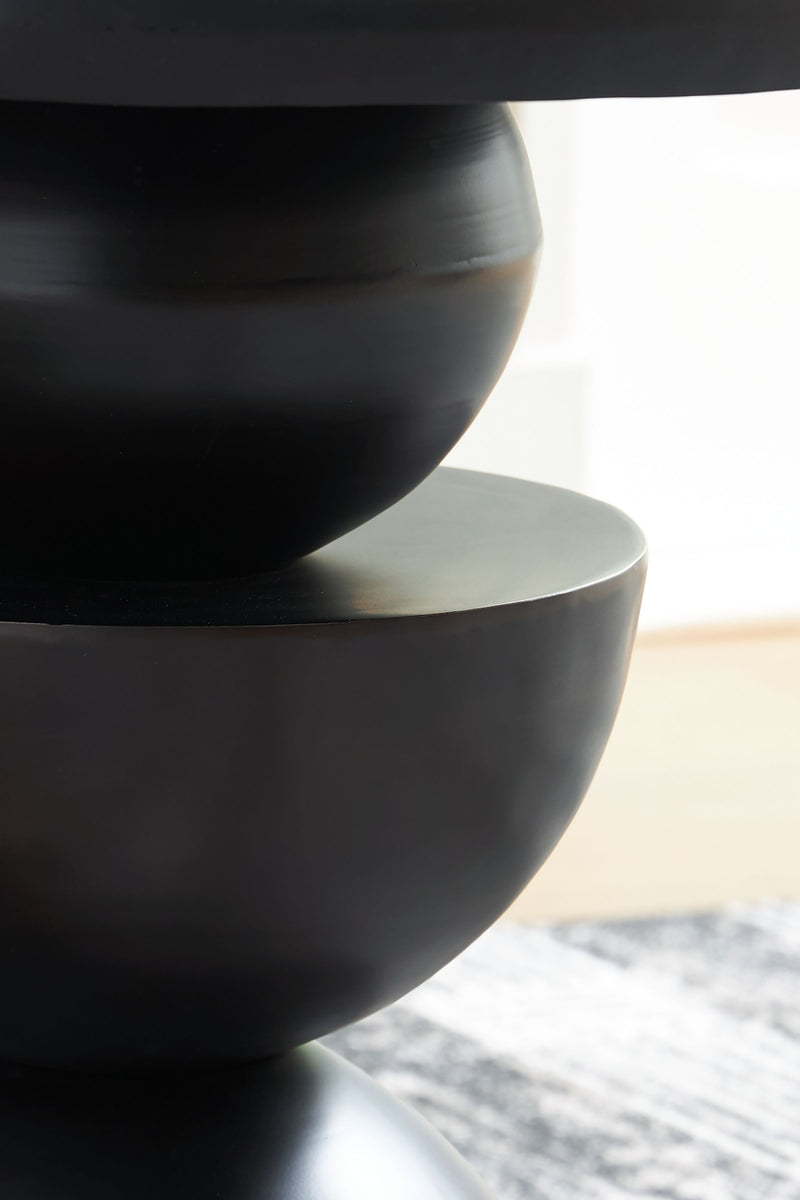 Bronze-finished accent table with round stacked base, close-up view