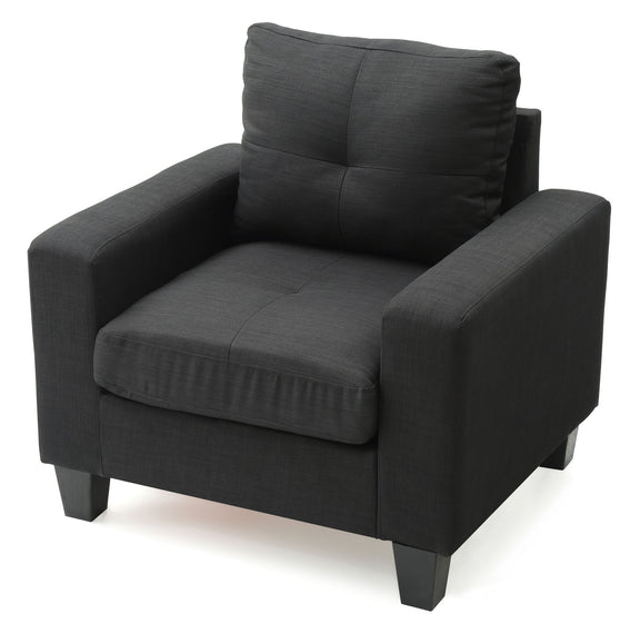 Dark gray upholstered accent chair with tufted back, padded arms, and thick seat