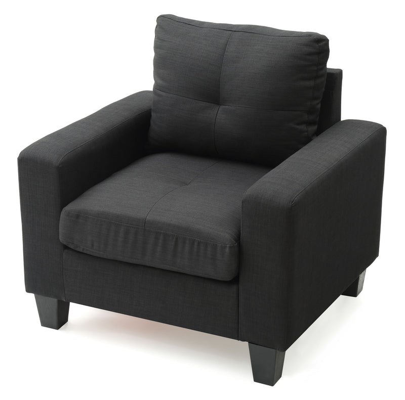 Dark gray upholstered accent chair with tufted back, padded arms, and thick seat
