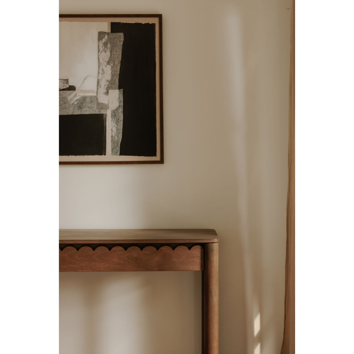 Vintage brown console table with scalloped apron detail under tabletop
