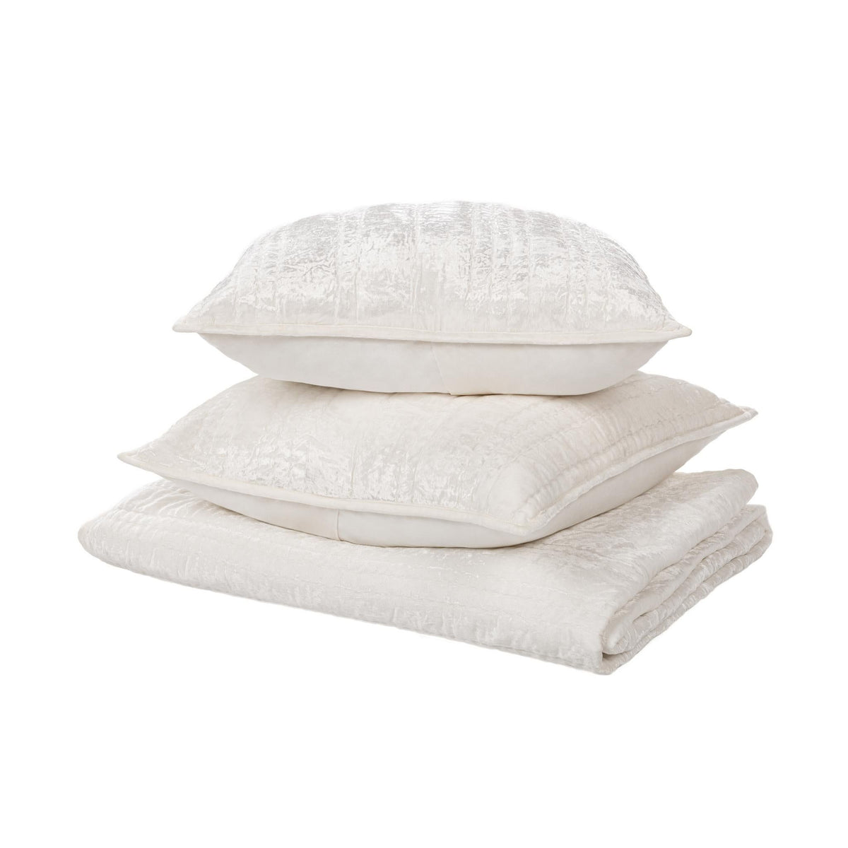 White quilted pillow shams stacked, with subtle texture and stitched edges
